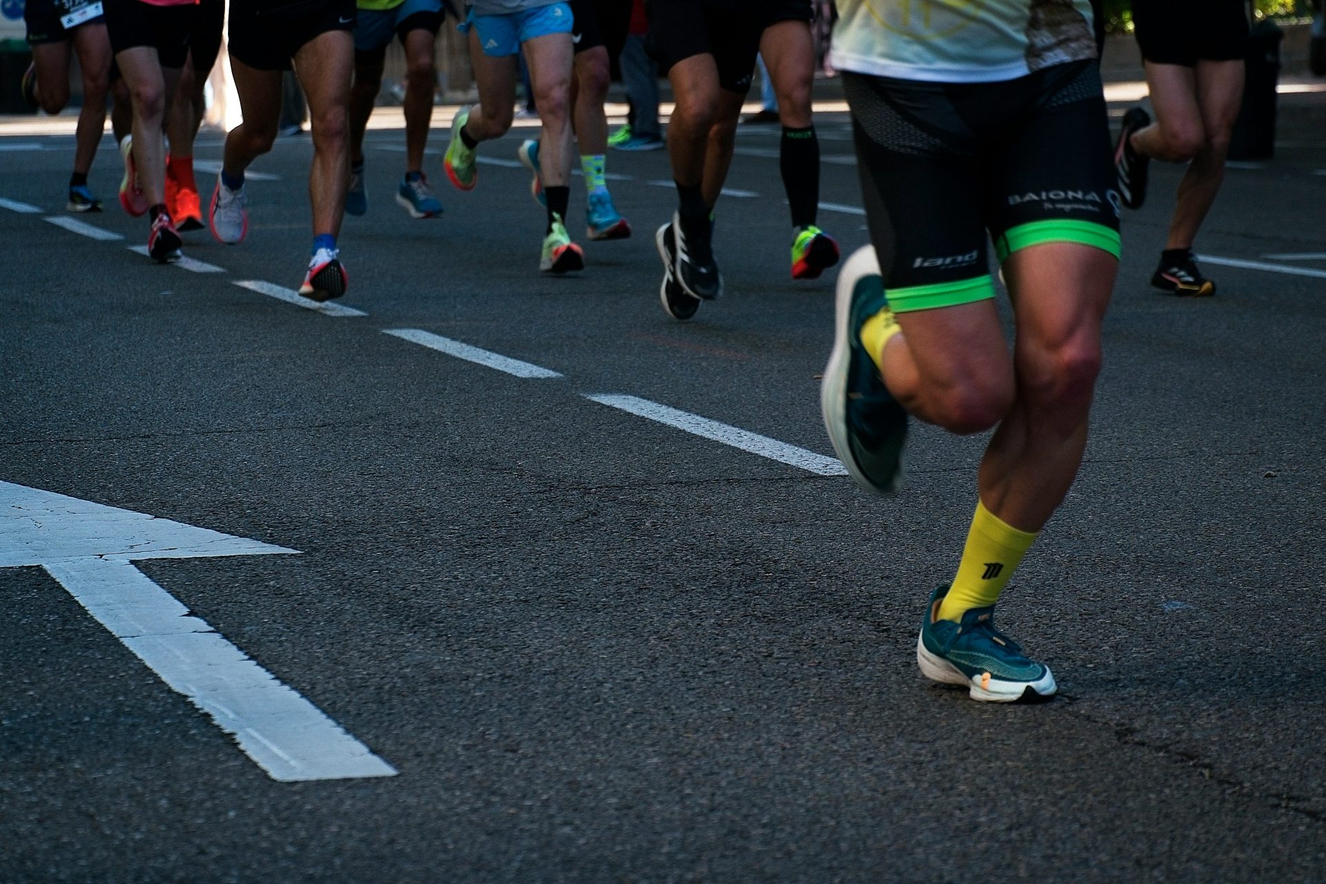 a group of people running down a street