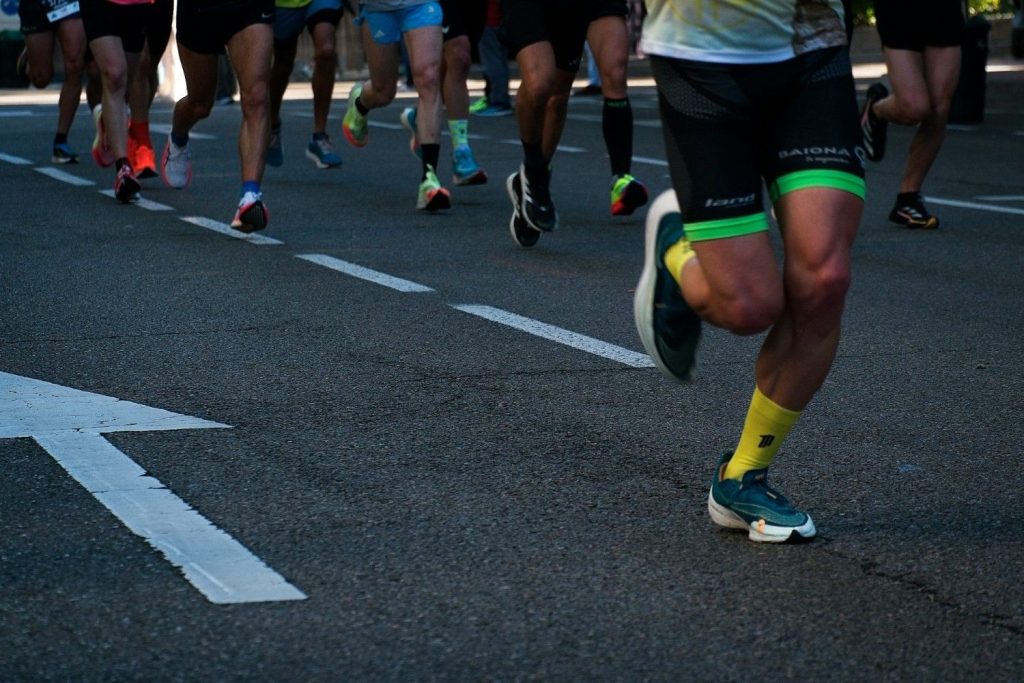 a group of people running down a street