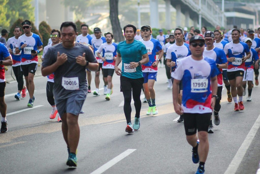 A large group of people running down a street